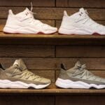 Nowoczesne sneakersy na drewnianych półkach w stylowej ekspozycji