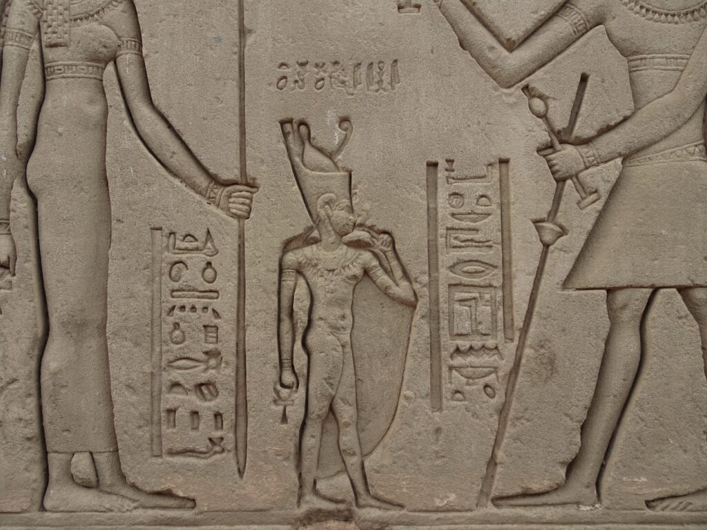 Kamienny relief z postaciami i hieroglifami starożytnego Egiptu